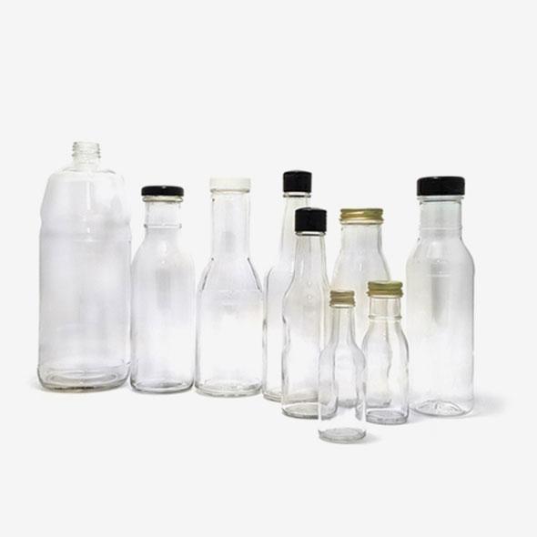A collection of clear glass woozy bottles