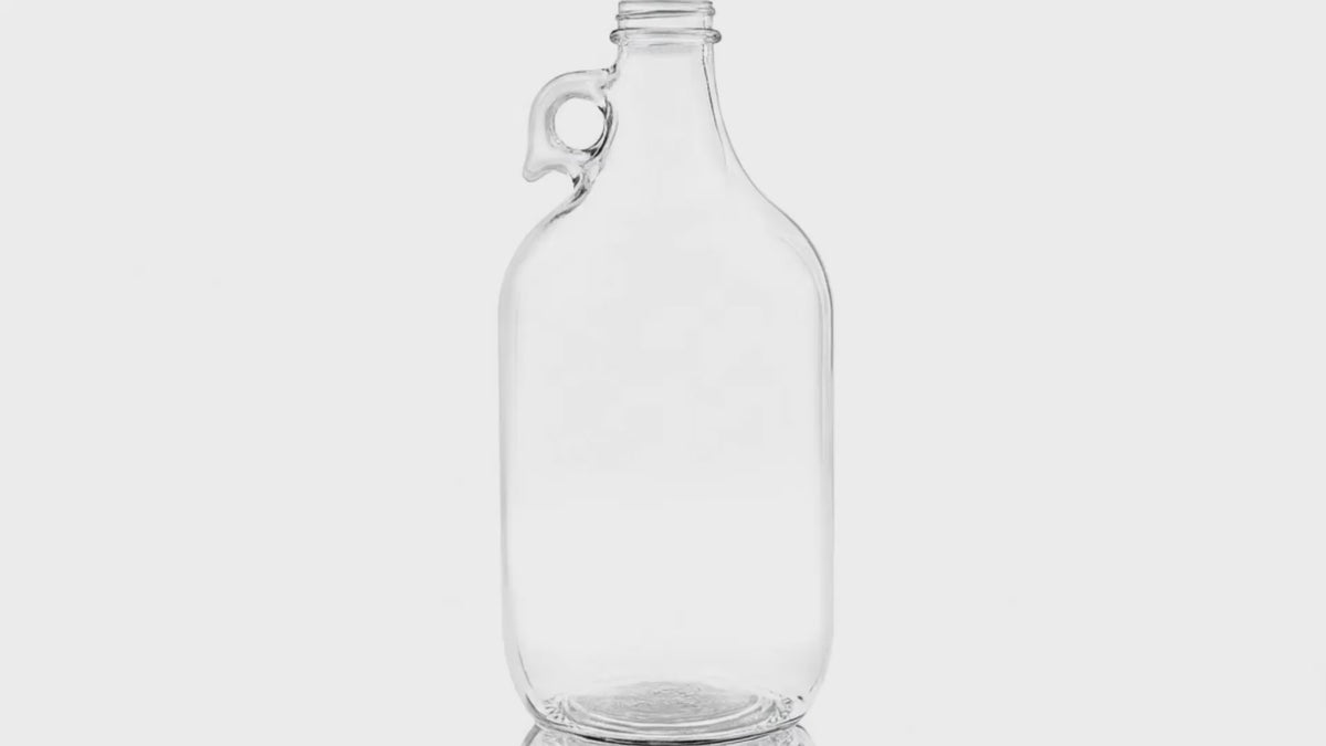 Load video: 64 oz Clear Glass Round Jug Bottle 38-400