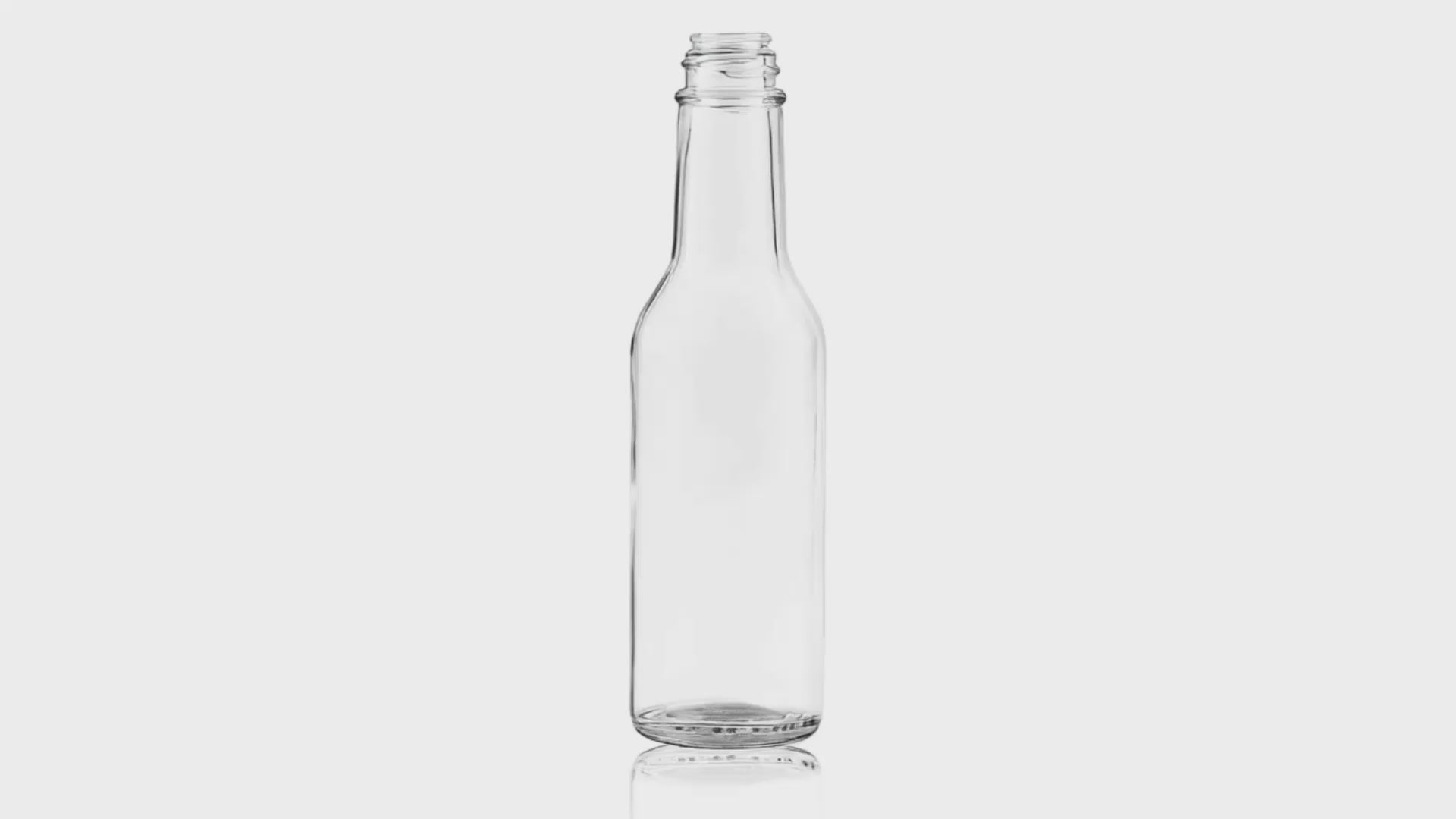 Load video: 5oz clear glass round woozy bottle